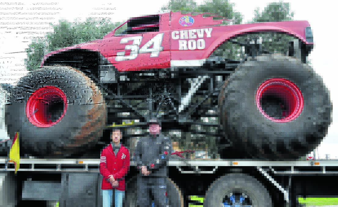 Chevy Roo the Monster Truck towers over Champion Post work experience student Thomas Nguyen and Troy Garcia from the Ultimate Monster Action Show.