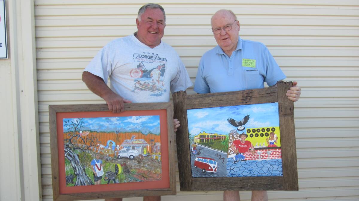 CALLING FOR ENTRIES: Csaba Belley and Men's Shed president Burnie Crowe inspecting Csaba's entries for this year's Australia Day art show.