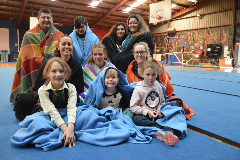 SNUG AS A BUG: Back, CentaCare housing support worker Andrew Bament, Jacob and Chloe Smith, and CentaCare housing support worker Rebecca Palenapa-Pili; middle, Vanessa and Teagan Smede, and Katie Shambrook; front, Evie Barnes (7), Abel Medlyn (3) and Luca Barnes (5), will all be rugging up on August 2 to help raise awareness of homelessness in the Central West.