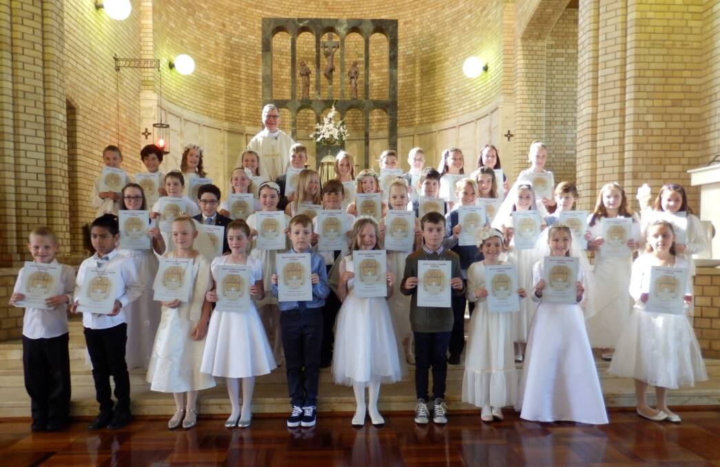 Pictured after the Mass are the 37 children with Father Barry Dwyer.