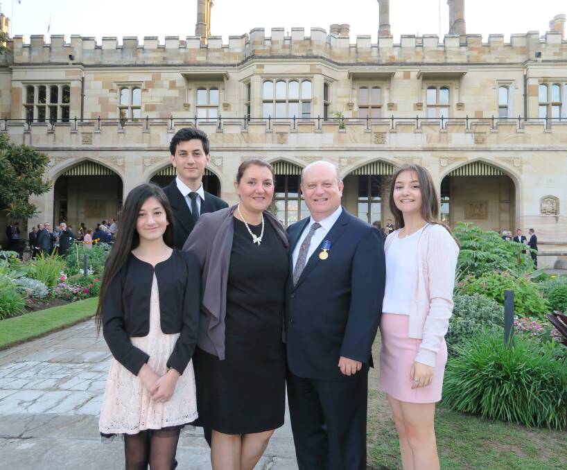 INVESTITURE: John Sarkissian (centre), accompanied by his family Lucin, Mihran, wife Anahid and Markarid, was presented his OAM at Sydney Government House.