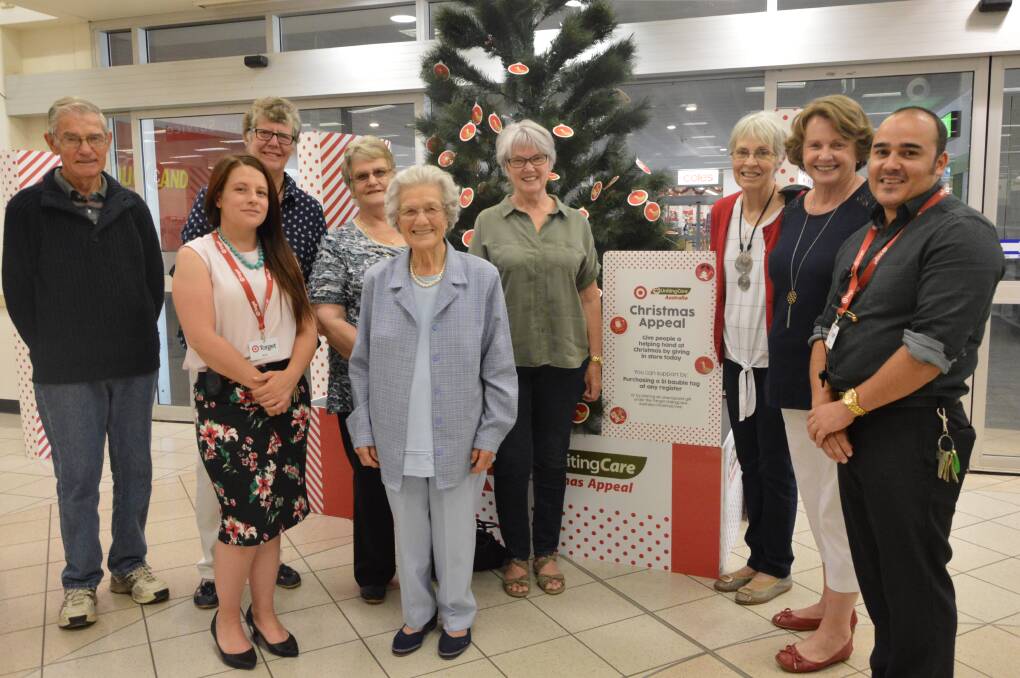 GIVING SEASON: At the giving tree at Target in Parkes, from left Ian and Joan Mill, Alexandria Giles (Target), Adrienne Bradley, Mary Stuart, Jan Ladbury, Evelyn Shallvey, Bev Hawken and Parkes Target store manager Kevin Bloomfield. Photo: Christine Little