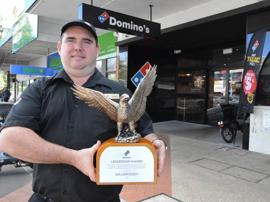 GREAT LEADER: Parkes Domino's franchisee William Cody with his five kilogram national leadership award from the Domino's Rally in Brisbane.