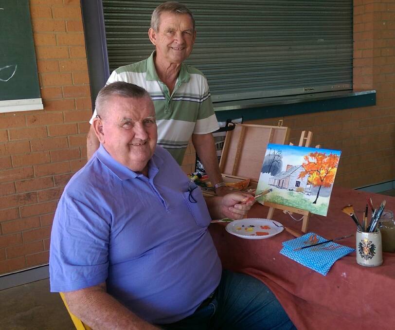 WELCOME: Parkes Painting Group member Kim Chambers welcomes a new recruit, Boyd Chambers, pictured with his artwork. The group is also getting ready to kick off their annual art exhibition this Friday.