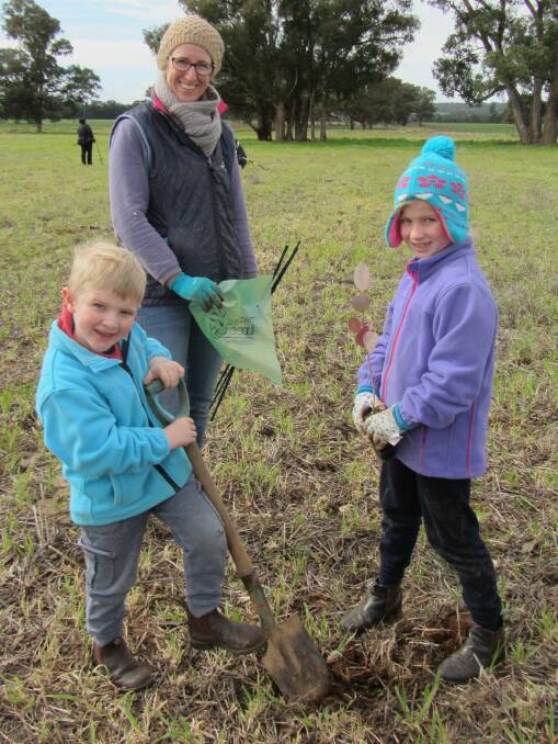Lucy and Tom Chapman with their mum Sally dig in and get ready for this year's National Tree Day event in Parkes.