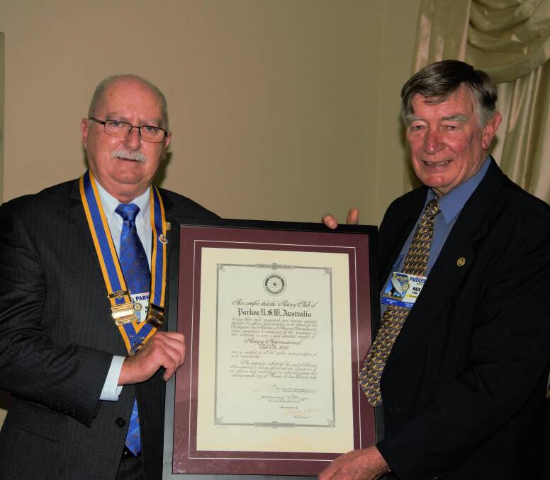 Outgoing president Rex Veal handed over the reins to 2016-17 president David Hughes at the Parkes Rotary changeover dinner at the Bushman's Motor Inn. Photos by Rosemary Richardson.