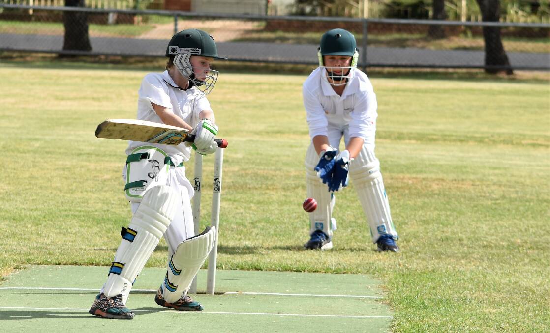 Parkes White batsman Connor Batt and Forbes wicket keeper Joe Morrison in action during the 2016-17 junior cricket season. Photo by Jenny Kingham