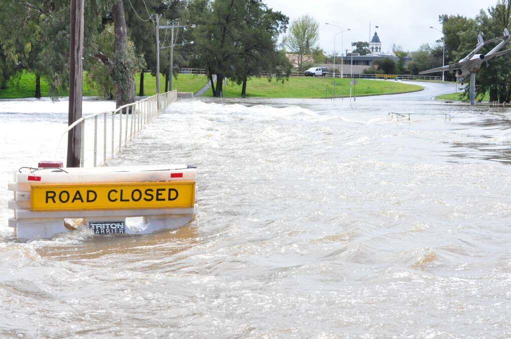 CAUTION: Flood waters gushing over Johnny Woods Crossing in Forbes.