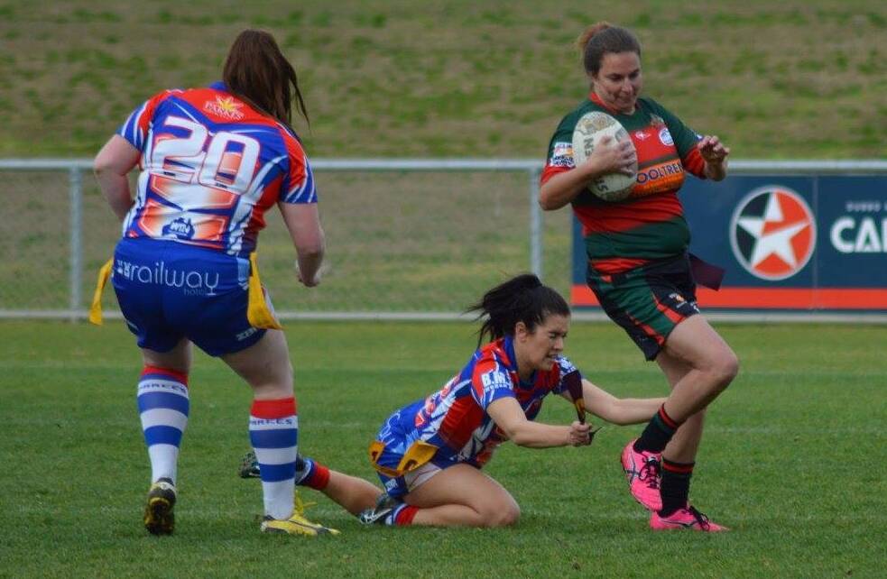 Ella-J Harris goes in for a successful tag of a Dubbo Westside player on Sunday, as teammate Brittany Dumesney watches on. Photo by Dubbo Westside.