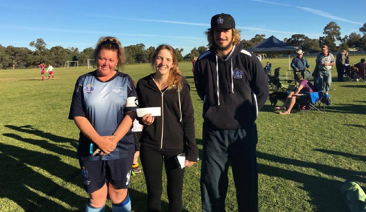 Parkes Hotel Football Club co-captain Renee Jones and the club's coach and secretary Malcolm Bruce donated a $100 cheque to Yasmin Potts.