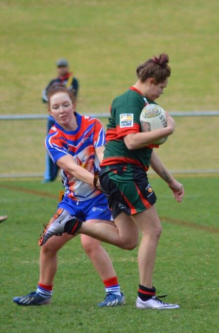 Parkes Spacecat Lou McAneney's efforts said it all as she tags a Dubbo Westside player at Caltex Park, Dubbo on Sunday. Photo by Dubbo Westside.