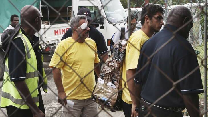 Injured: Asylum seekers at Manus Island airport leave for Port Moresby. Photo: Nick Moir
