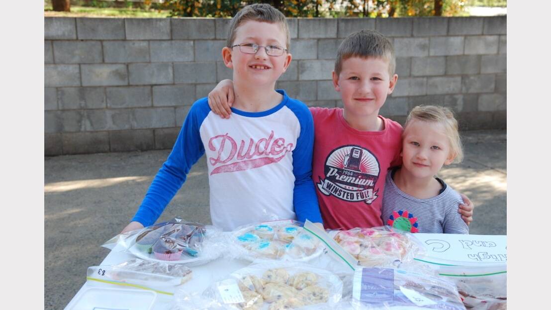 ELECTION 2013: Patrick, Lachlan and Layla Kupkee check out the goodies. Photo: Parkes Champion Post