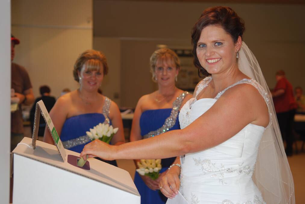 ELECTION 2013: Parkes, Lachlan and Forbes Shires Roads Safety Officer, Melanie Suitor got married on Saturday, and called in to the Coventry Room at the Parkes Library to record her vote on the way to the wedding ceremony.  She is pictured with her attendants, her attendants Melissa Archer and Claire Donlan. Photo: Parkes Champion Post