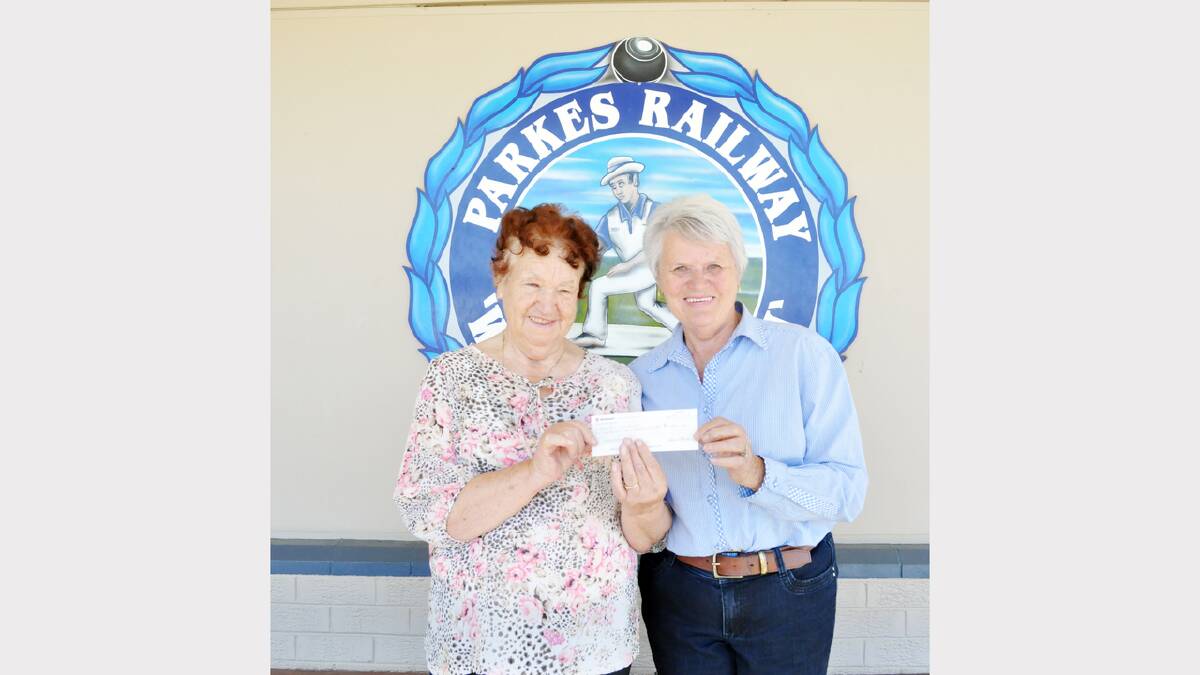 Evelyn Gibson and Helen Heraghty were pictured with a cheque from the Combined Charity Bowls Day for Look Good, Feel Good. The day raised $1100 for the Wig Library Parkes. Photo: Denis Howard  