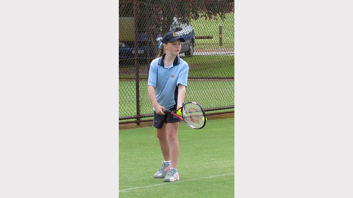 Emily about to send down a serve at the Parkes Tennis Centre. sub 