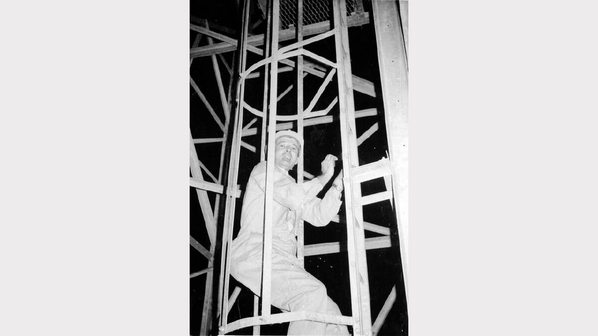 Cliff Bradley climbs the tower to remove the culprit tag and save  the Apollo 13 mission. The action prompted strict confidentiality. 