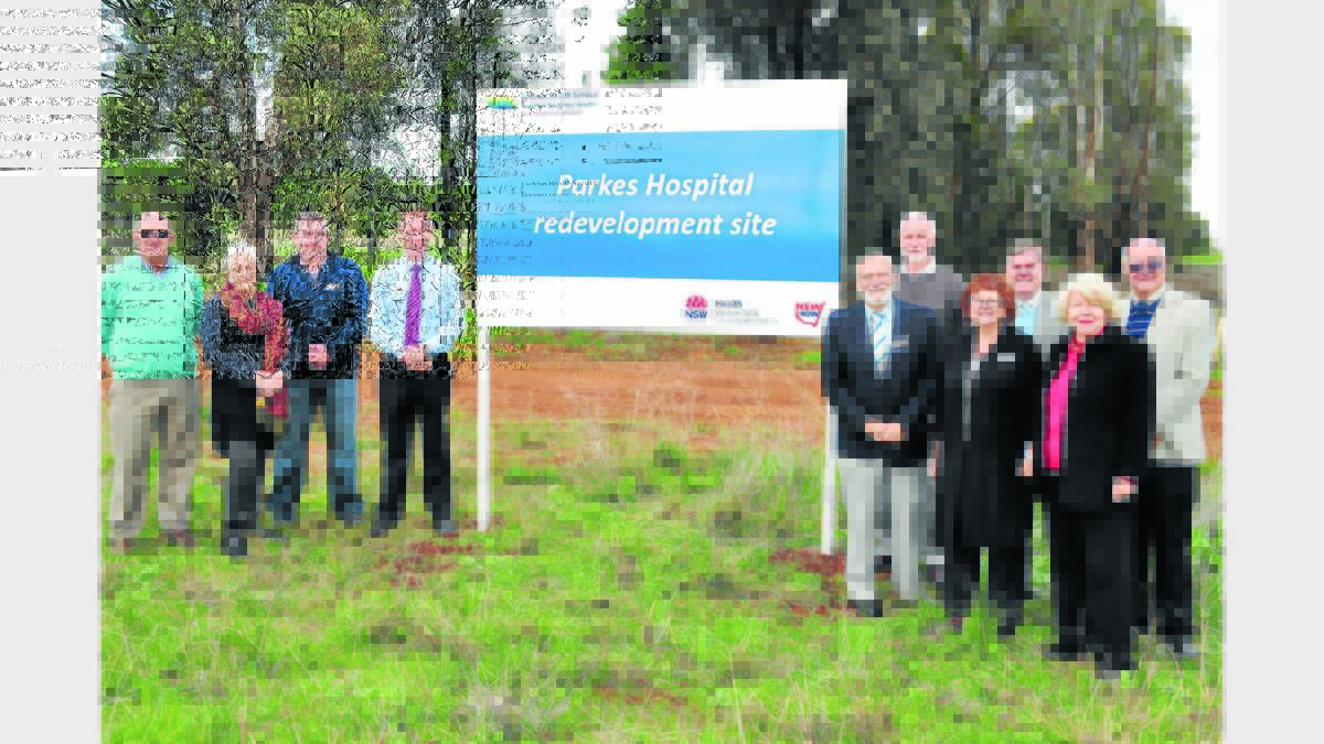 A sign has been set up indicating the site of the proposed new Parkes hospital. Pictured at its unveiling last week are (left to right), Paul Mann (Board member Western NSW L.H.D.), Julie Ann Maher (Board), Jeff Morrissey (Director Corporate Services), Scott McLachlan (Chief Executive), Professor Joe Canalese (Board), Scott Griffiths (Board), Lindsey Gough (Director Operations), Dr Robin Williams (Board Chairman), Joan Treweeke (Board) and Dr John Tooth (Board).  Photo: Bill Jayet  