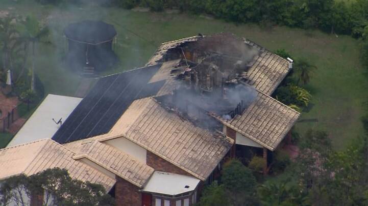 Flames engulfed the roof of Adam Brand's Gold Coast home. Picture via Seven News