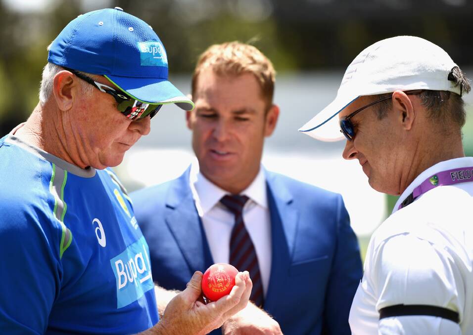 Colour conscious: Former Australian cricketers Craig McDermott and Shane Warne give a pink cricket ball a close look. Picture: Getty Images