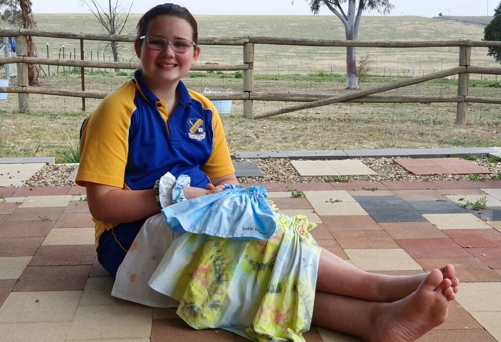 SHOWING SUPPORT: Year 6 Eglinton Public School student Charlotte Rochester, with some of her skirt and scrunchie creations. Photo: SUPPLIED