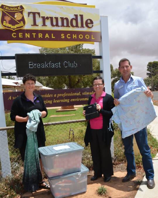 DONATIONS: Neighbourhood Central delivered clothes and bags to Trundle Central School from a generous Jill Thompson of Sydney. Pictured is Kylie Strudwick, Ann-Marie Taylor and Roger Kitson. Photo: Trundle Central School Facebook page