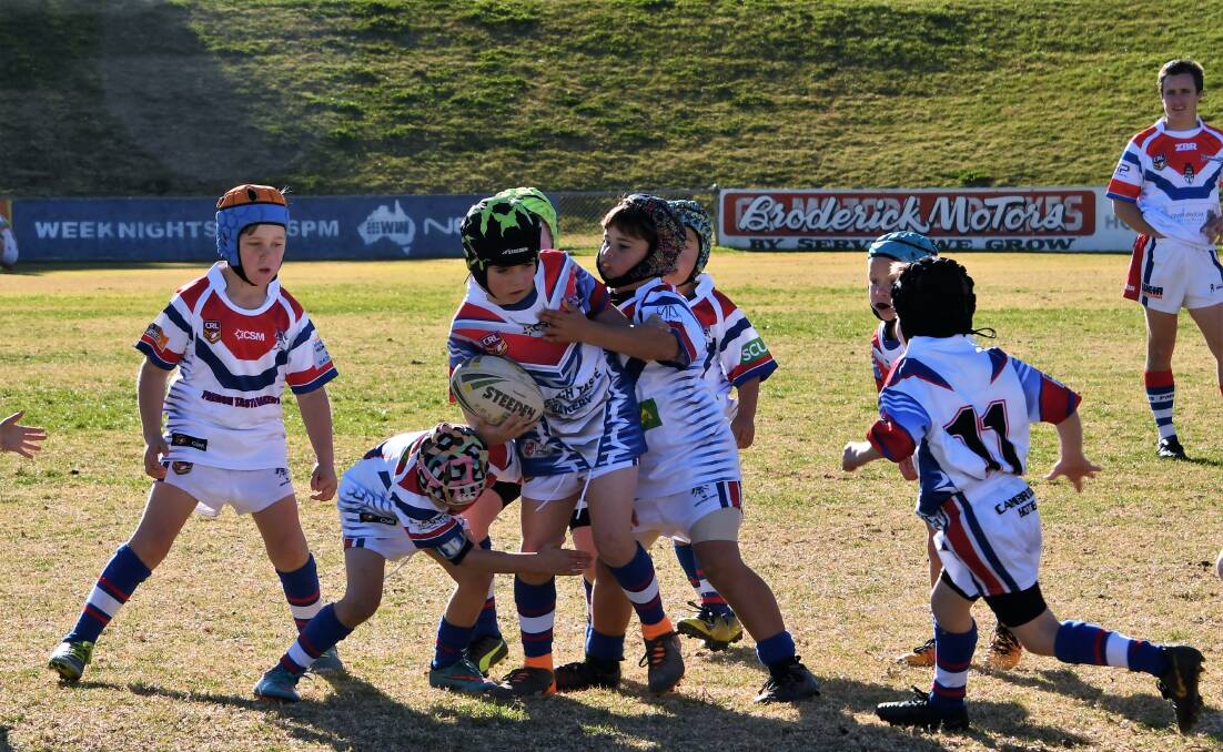 JUNIOR LEAGUE: Parkes Marist Junior Rugby League players had the opportunity to join the Parkes Spacemen on the field during a home game in June. Pictured is Carter Moran with the ball, and his team mates. Photo: Jenny Kingham