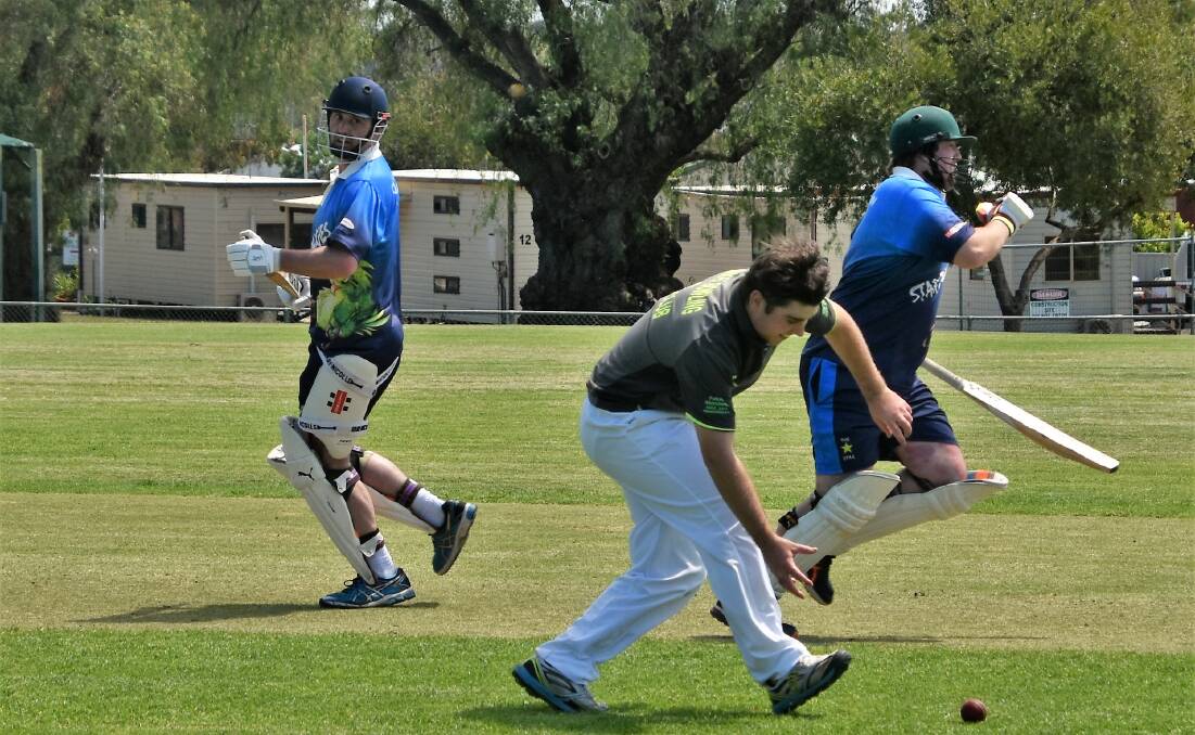 Nice Work: Star Hotel Budgies batsmen Matt Clarke and Mitch Townsend Parkes Bowling Club bowler Nathan Hessel picks up the ball.