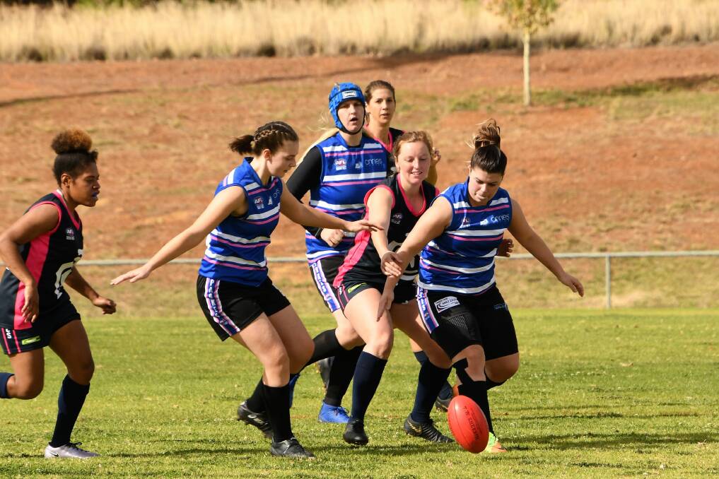Pantherettes Amber L'Estrange, Corine Coleman and Katie Hetherington battle it out with the Cowra Blues. Photo by Jenny Kingham.