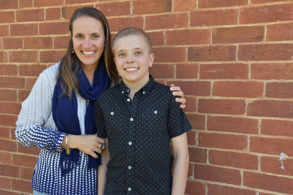 SUPERSTAR: Despite living in constant pain, 15-year-old Hamish Neville is passionate about raising awarness around the condition that plagues him. He is pictured with his mother Libby. Photo: Barbara Reeves. 
