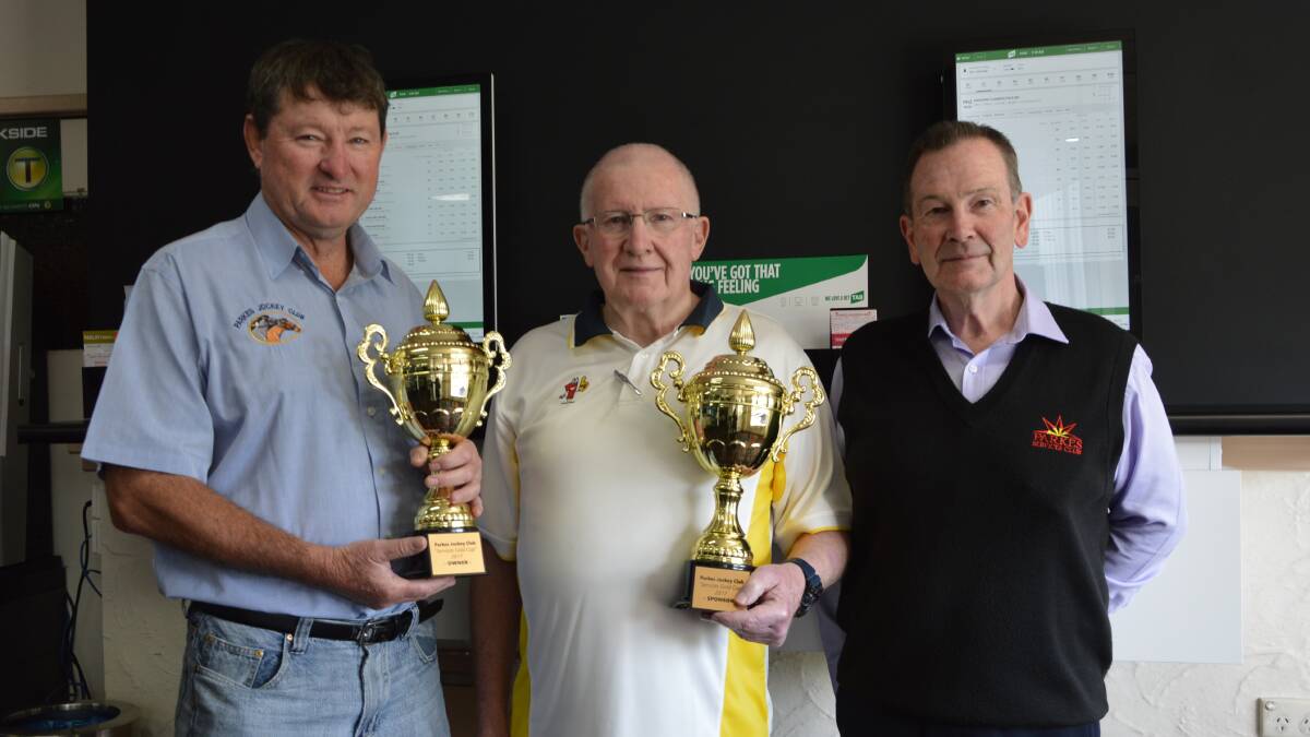 GOLD CUP: Parkes Jockey Club president Mark Ross, Parkes Services and Citizens Club president Terry Knowles, and general manager Denis Lane with two of the four Gold Cup trophies. Photo by Barbara Watt. 