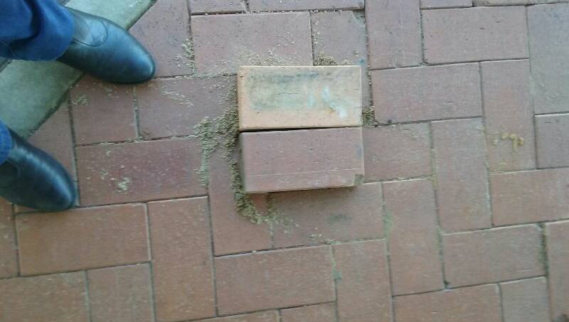 THUMBS DOWN: These loose pavers were left unattended, without any warning signage while council workers went to find materials to fix the hole underneath. 