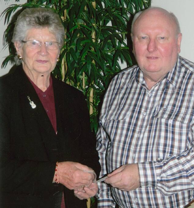 Frances Charlton accepted a donation of $200 from Orana Country Music Club representative Garry Hollier. 