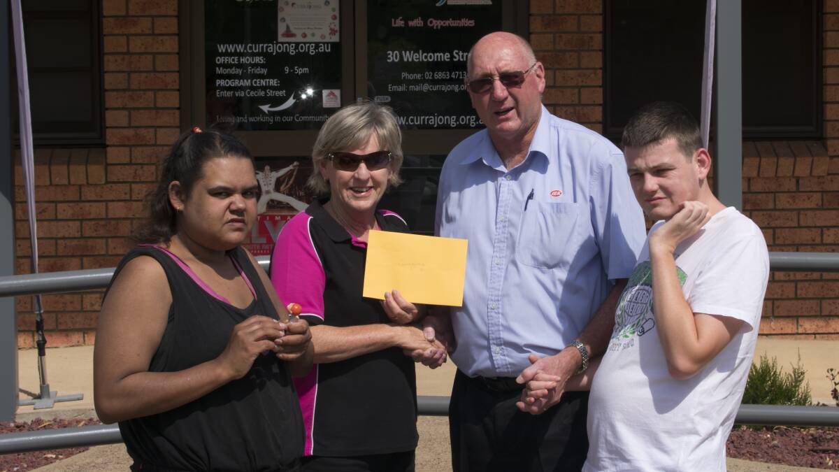 LONG TIME SUPPORT: Shaquille Peachy, Debbie Hewitt and Jarrad Simpson from Currajong Disability Services accept a cheque from IGA's Peter Boschman. 