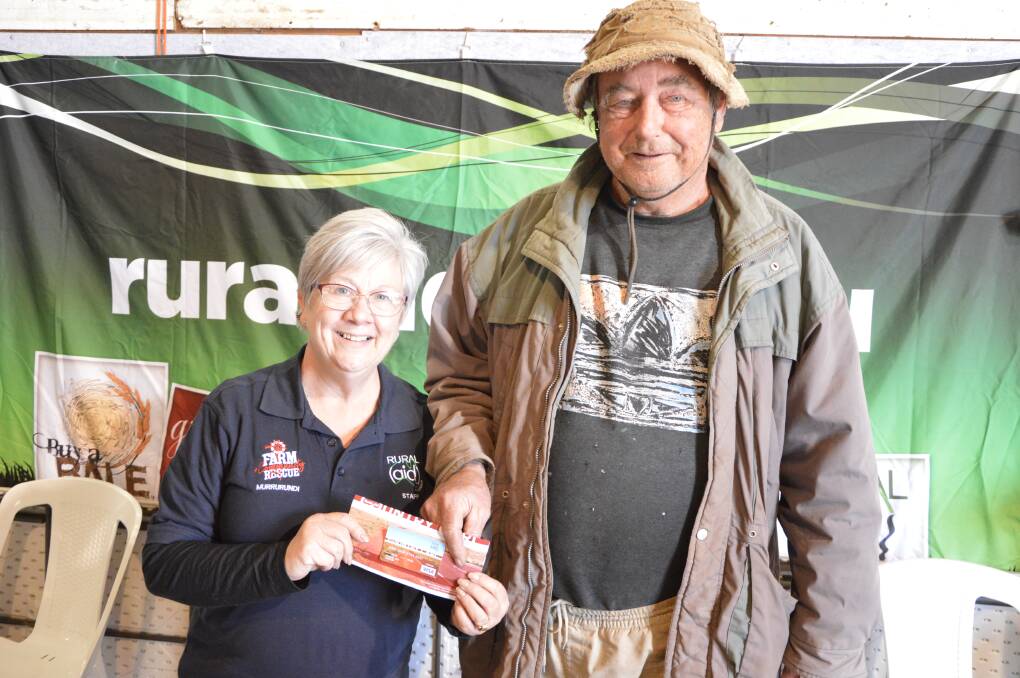 RECIPIENT: Bogan Gate farmer Ludek Wolf collected his $500 Country Card from Rural Aid Farm Army program manager Julia Hahn, from Brisbane. Photos: Christine Little.
