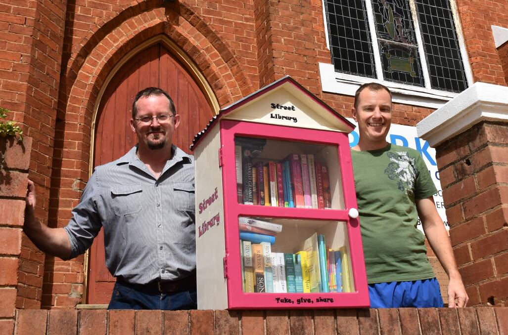 ON THE STREETS: Reverend Craig Bland and Daniel Greef with Parkes' first Street Library. Photo: Barbara Reeves. 