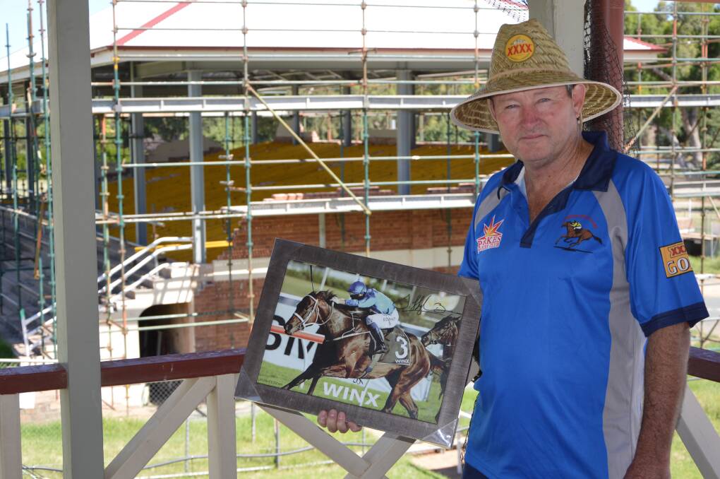 Parkes Jockey Club President Mark Ross is pictured with the Winx print, signed by Hugh Bowman, to be raffled at this Saturday's Australia Day Weekend race meeting.  