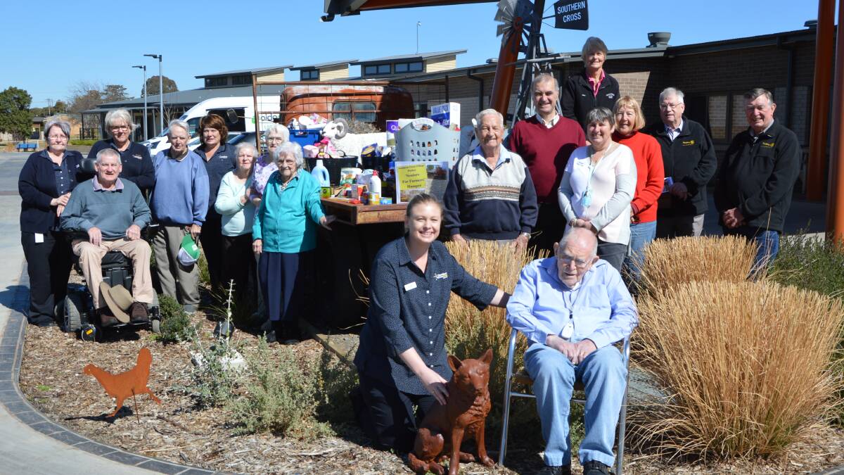 Southern Cross Care residents, staff and volunteers, and Parkes Rotary Club members posed with the items collected before they were handed over. 