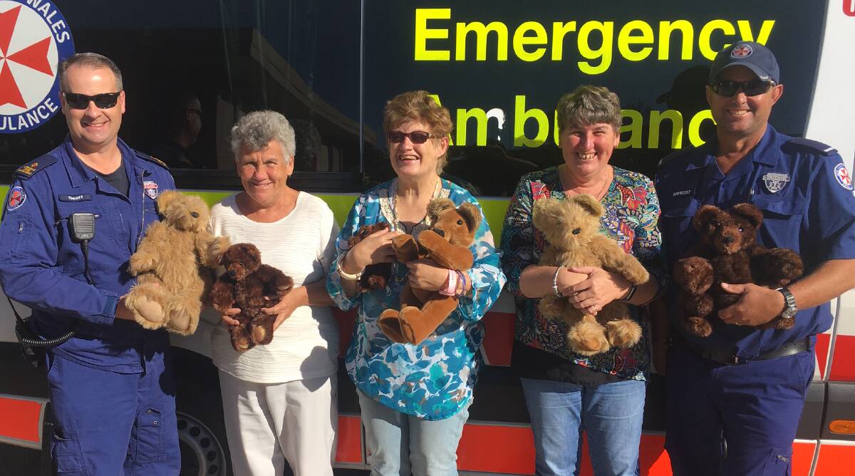 HAND MADE WITH LOVE: Paramedic Geoff Lovegrove, Dearnne Callaghan, Karen Willis, Cherie Lovett and Parmedic Graham Turner with the bears donated to Parkes Ambulance Station. Photo: Supplied. 