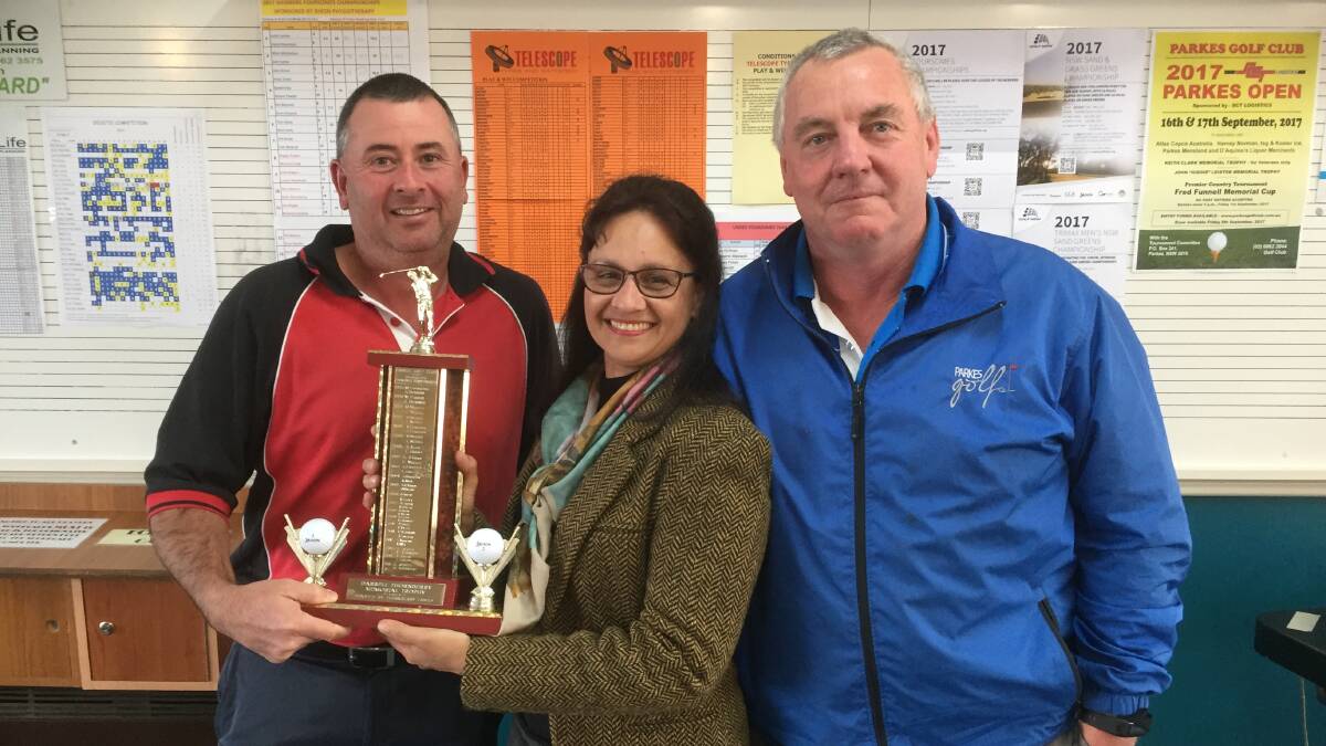 Sharon Dixon presented the Foursomes Championship trophy to John Green and Peter Dixon last year. 