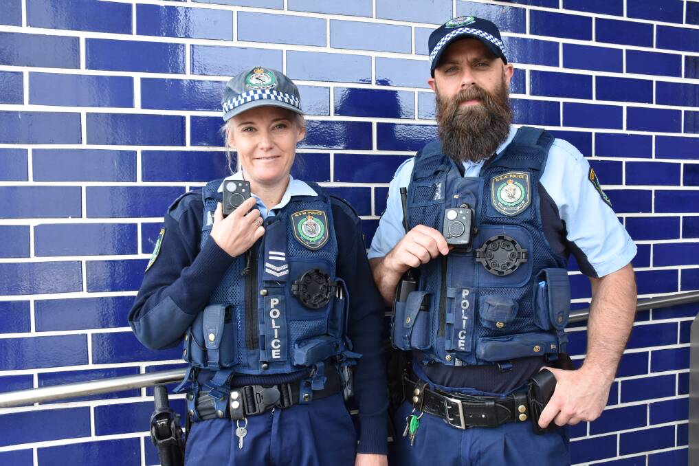 FRONTLINE POLICING: Parkes police officers Leading Senior Constable Lauren Searle and Senior Constable Brian Mann with their body worn video cameras. Photo: Barbara Watt. 