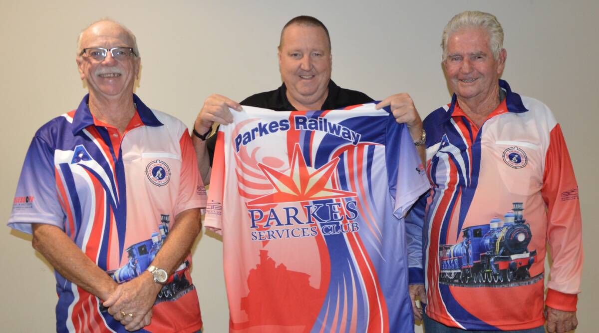 Railway Bowling Club members Mick Furney (Junior Vice President) and Terry Hetherington (Bowls Secretary) with Services Club Assistant Manager Mike Phillips (centre) and the new shirts. 
