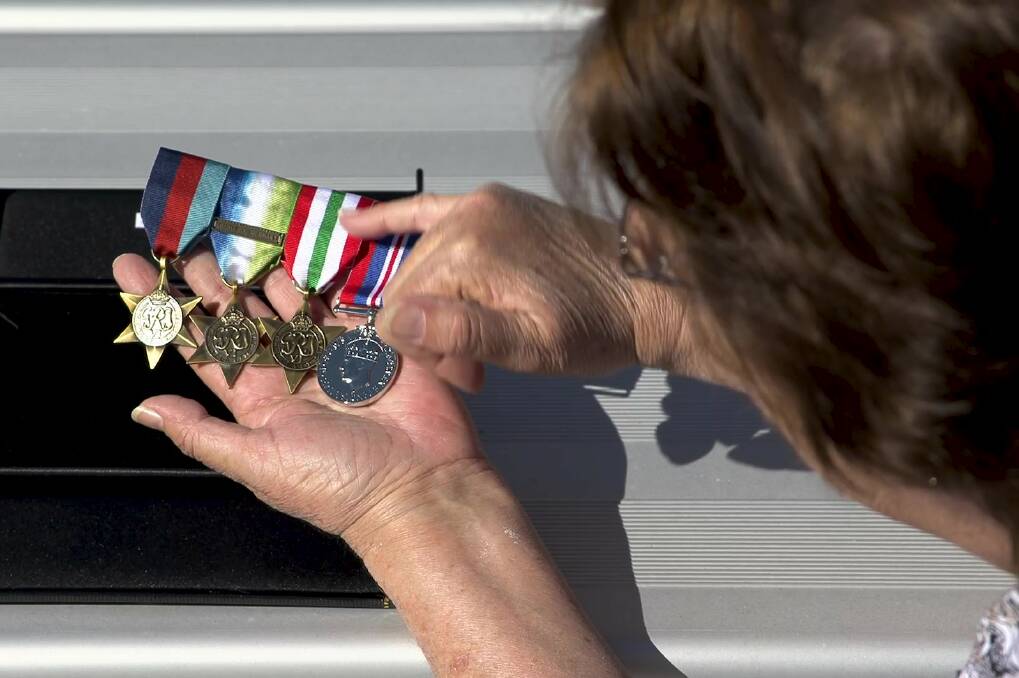 Brenda Melling with replicas of her father's war medals.