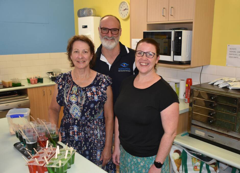 HANDING OVER THE BATON: Lindy Napier with Parkes East principal Michael Ostler and new canteen manager Fiona Francis.