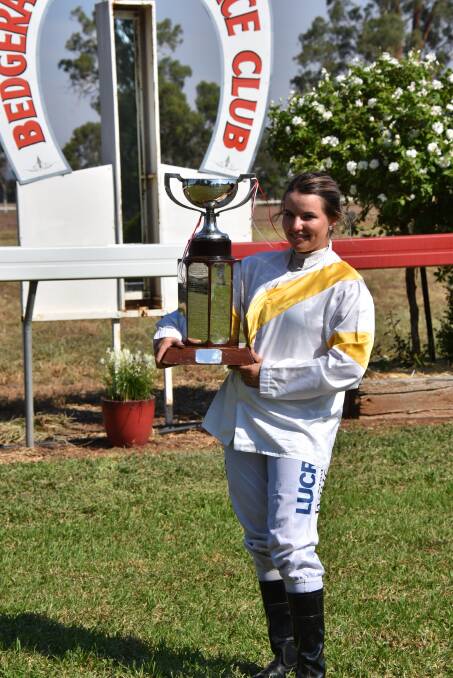 Maddison Wright holds aloft the Bedgerabong picnic races cup in 2018.