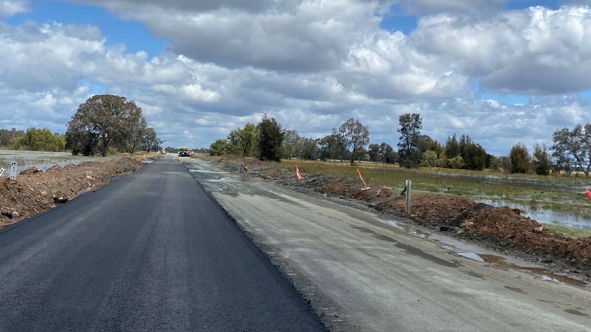 Transport for NSW built earth bunds on the sides of the Newell Highway and pumped water off before beginning resurfacing works. The road needs heavy duty asphalt in a thicker layer so to withstand future inundation. 