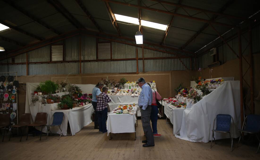 CANCELLED: Visitors admire the pavilion exhibits at the 2018 Eugowra Show, but the event will not go ahead this year with concerns about coronavirus again on the increase. Photo: File photo
