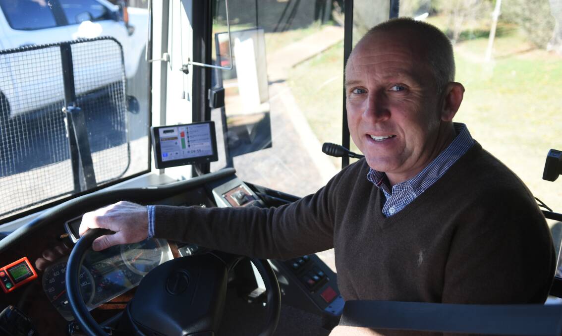 Western Road Liners manager Chris McQuie in the driver's seat with the new tracking system the drivers log onto. 