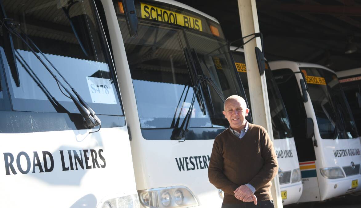 READY TO ROLL: Western Road Liners manager Chris McQuie with the numbered buses. Photo: Renee Powell.