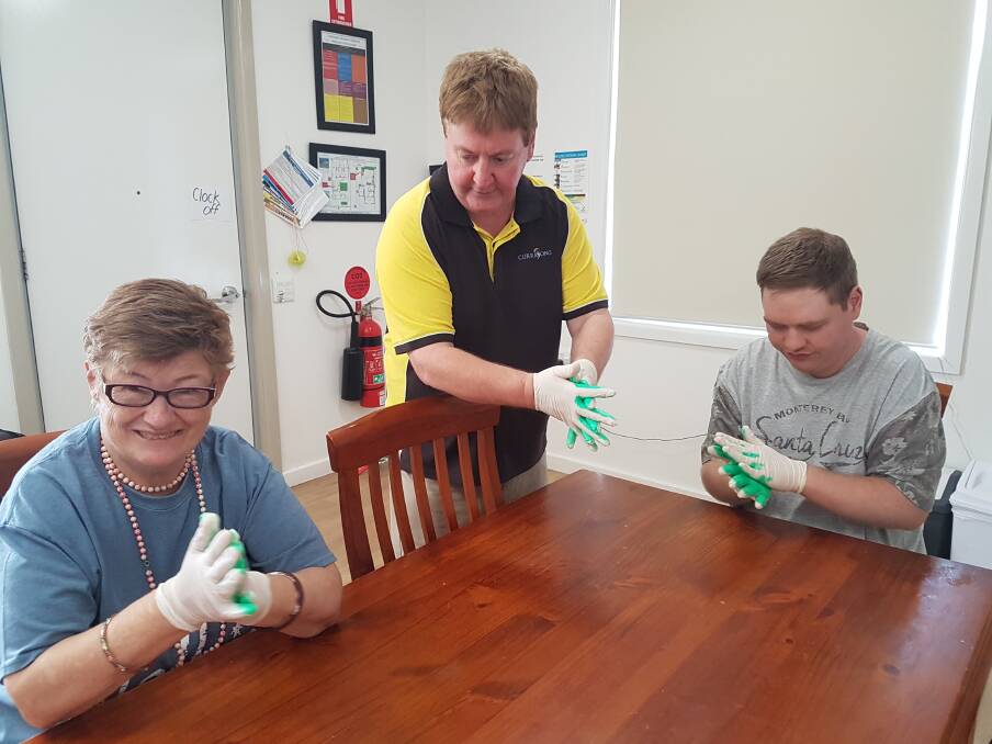 Scott Salter, one of Currajong's most experienced support workers with Karen Willis and Jay Crouch reinforcing proper hygiene.